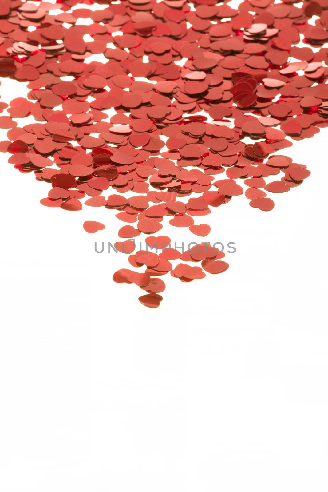 small red hearts confetti isolated on white background