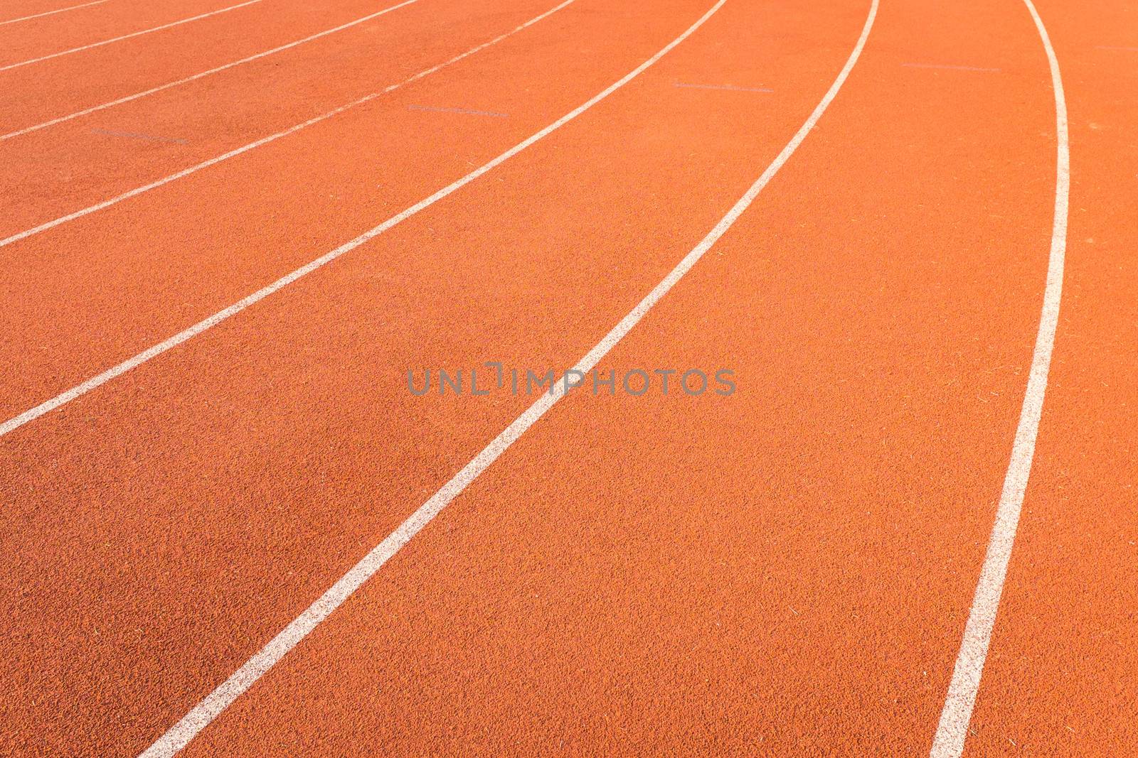 athletics track lanes with white line by moggara12