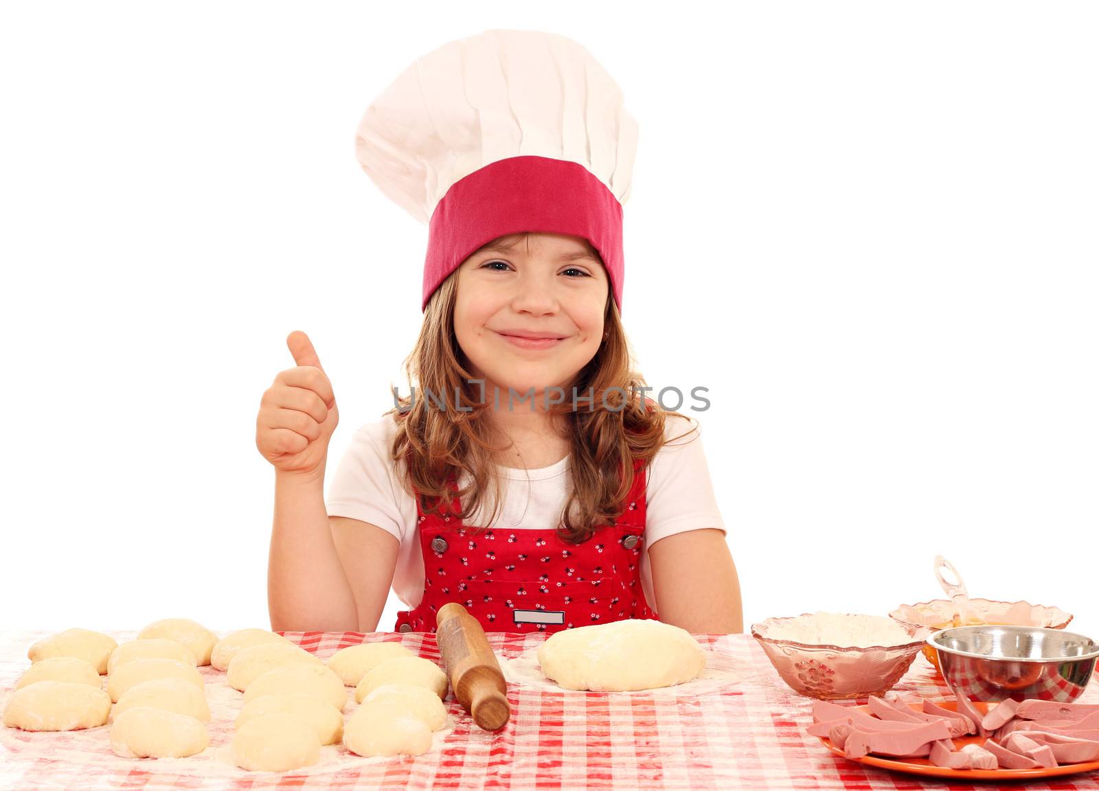 happy little girl cook with dough and thumb up by goce