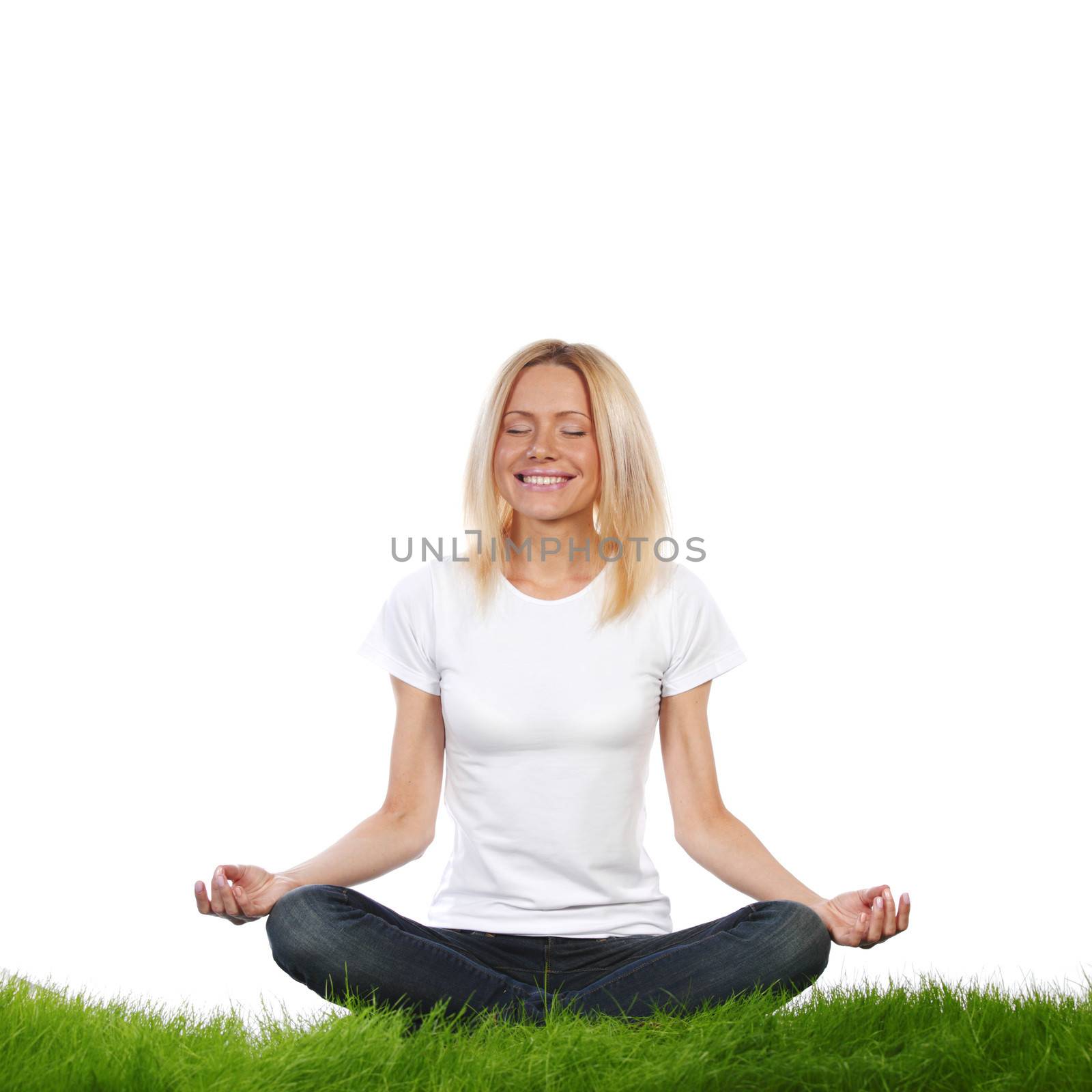 Woman in lotus position sitting on grass, studio isolated on white background
