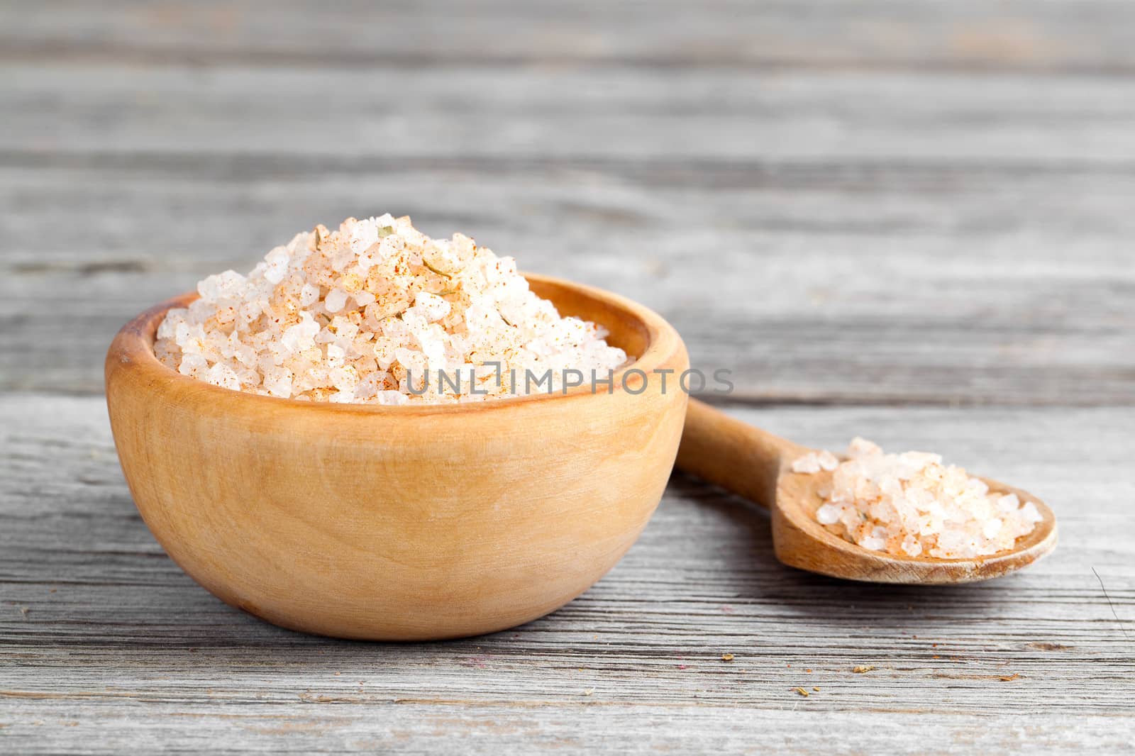 Pink salt  in the wooden bowl, on wooden board