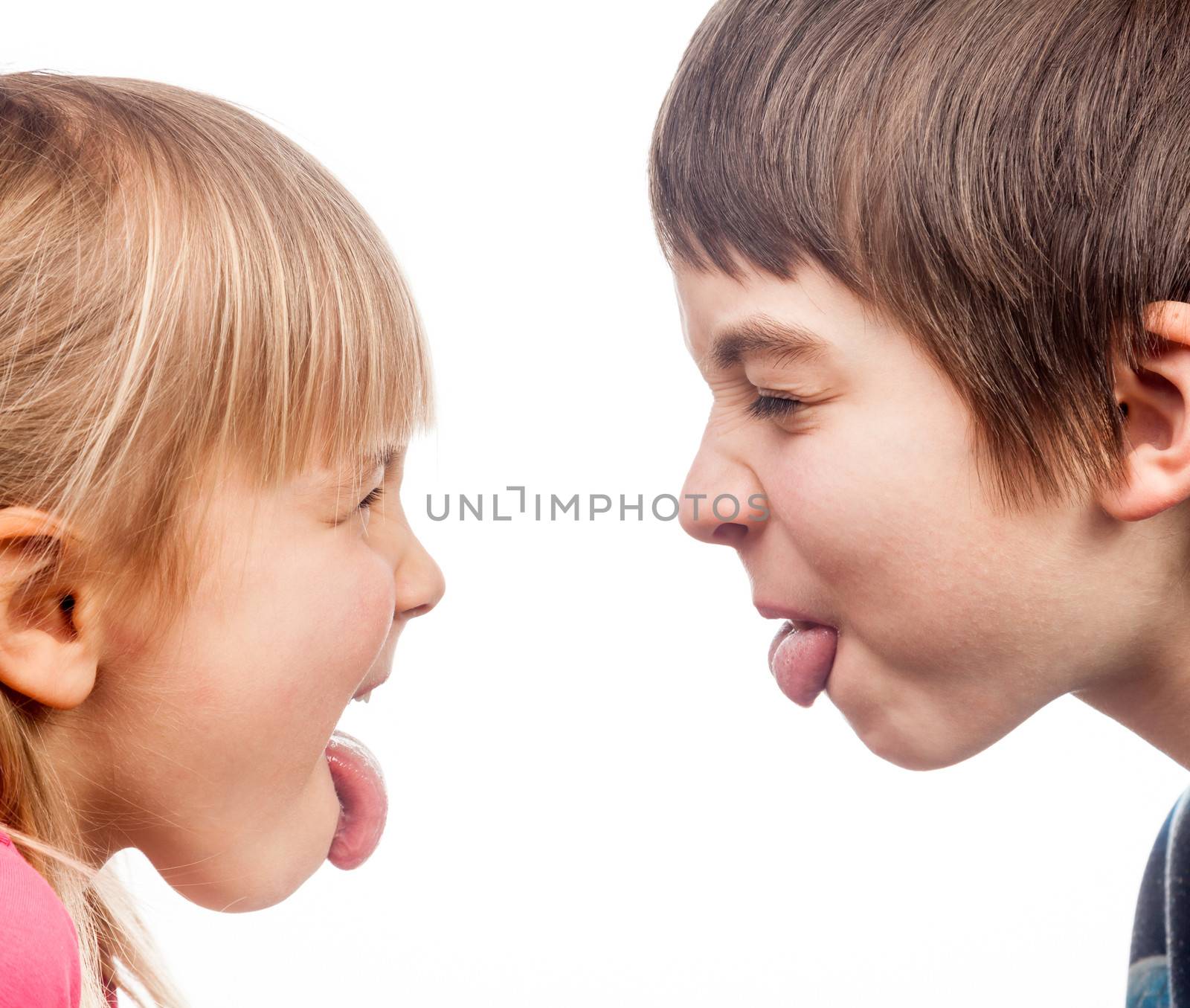 Sister and brother stick out tongues to each other