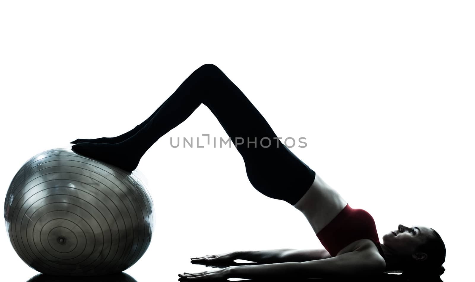 one caucasian woman exercising fitness ball in silhouette studio isolated on white background