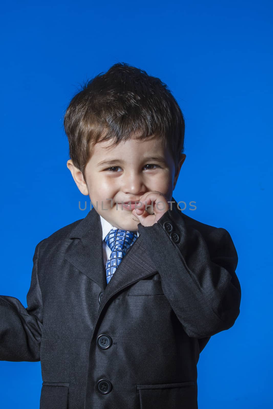 Leader, cute little boy portrait over blue chroma background