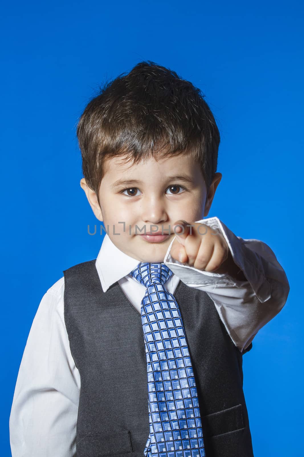 Leader, cute little boy portrait over blue chroma background