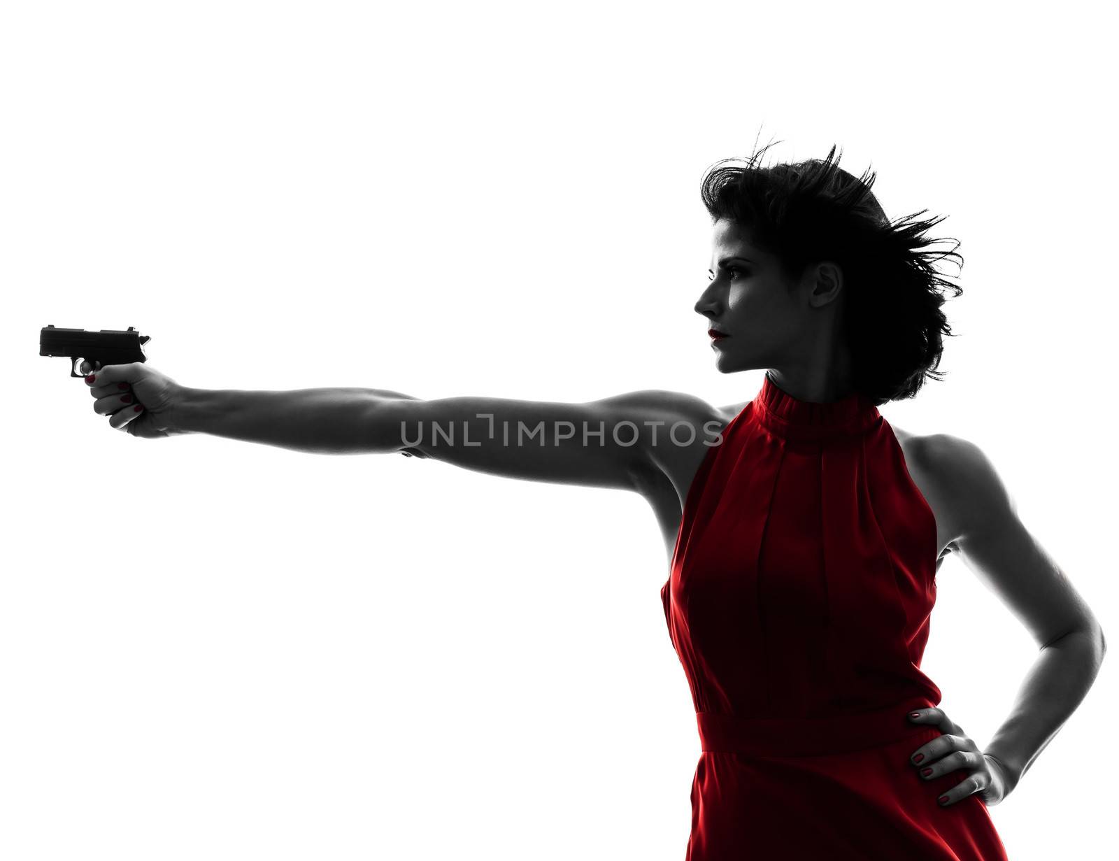 one sexy caucasian woman holding gun in silhouette studio isolated on white background