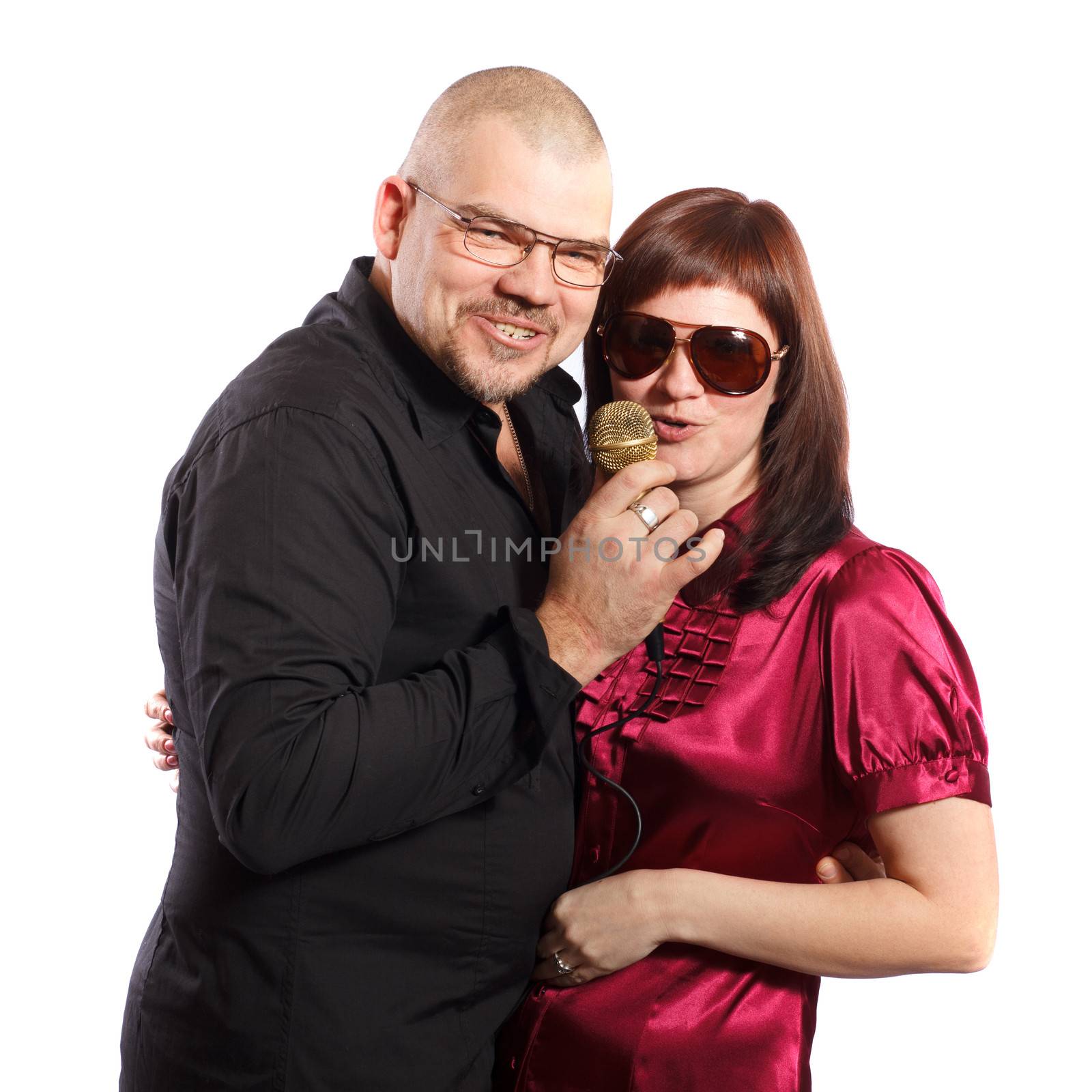 middle age couple sing karaoke on a white background