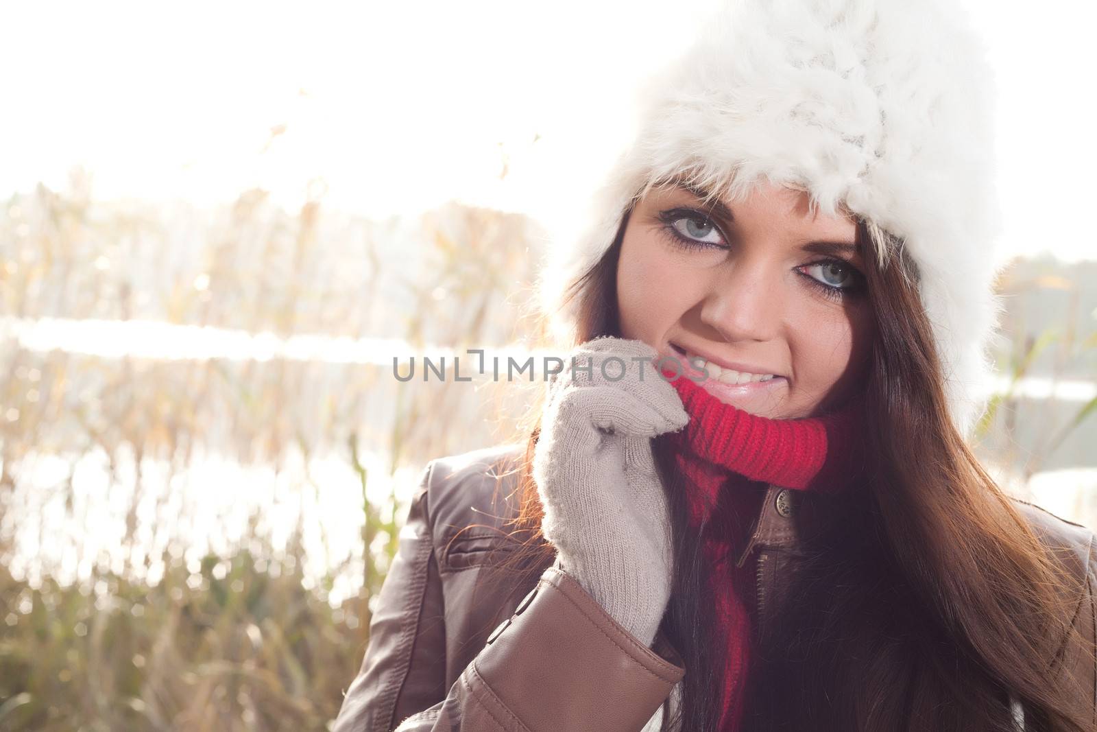 Happy brunette is having a nice time in the park while it's autumn