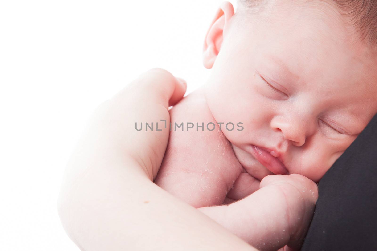 happy newborn baby girl just a week old photographed in the studio