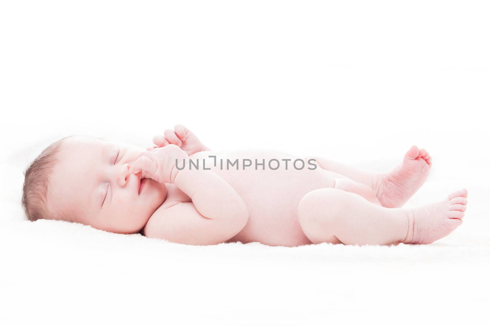 happy newborn baby girl just a week old photographed in the studio