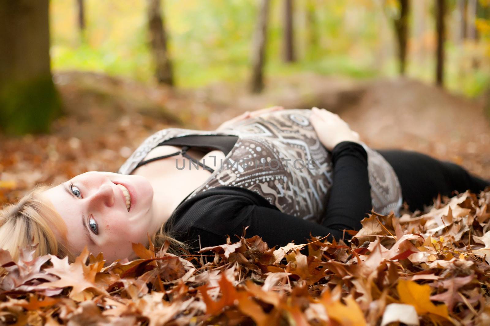 Smiling pregnant woman in the forest by DNFStyle