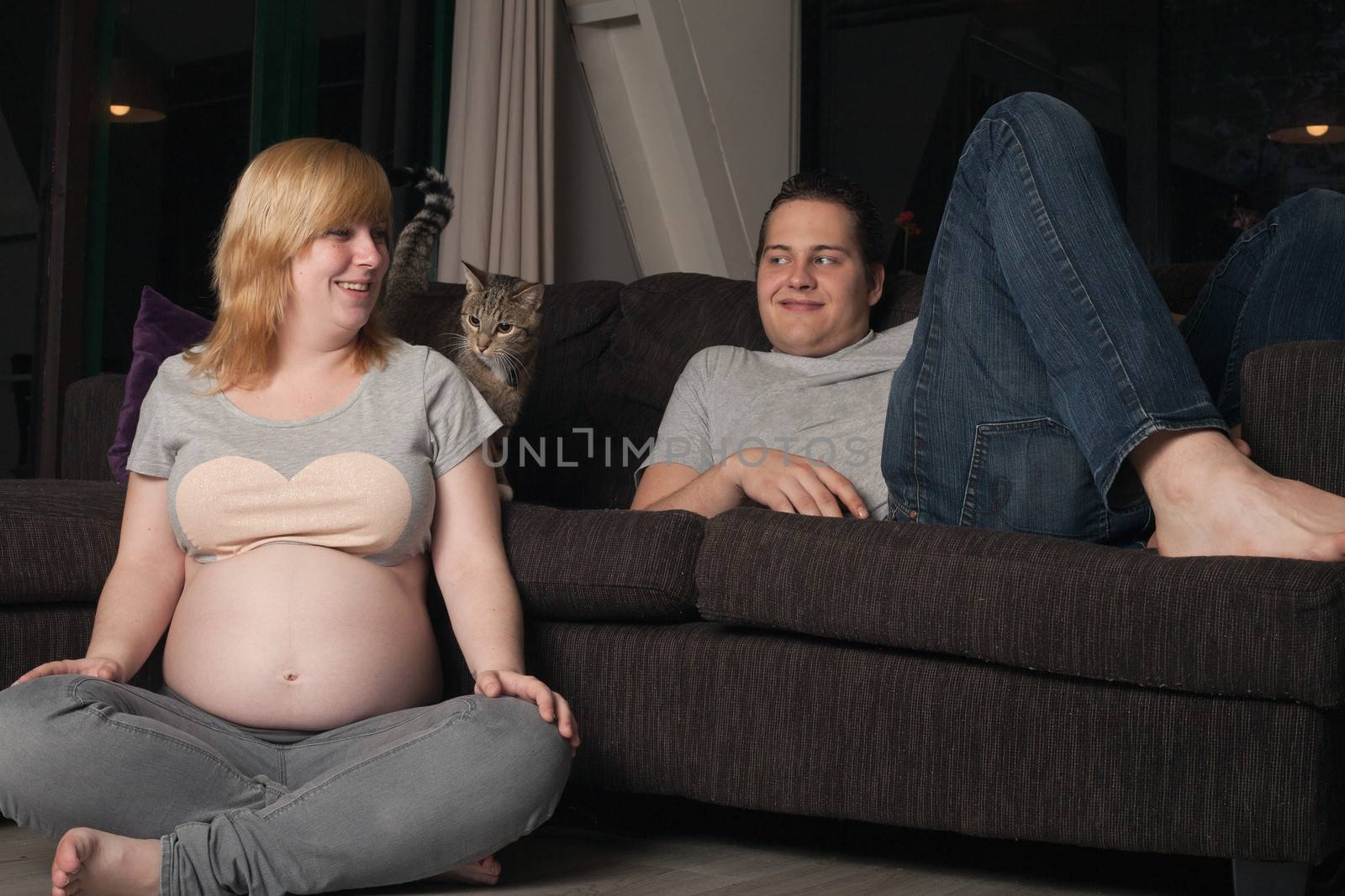 Pregnant couple with the cat at home by DNFStyle