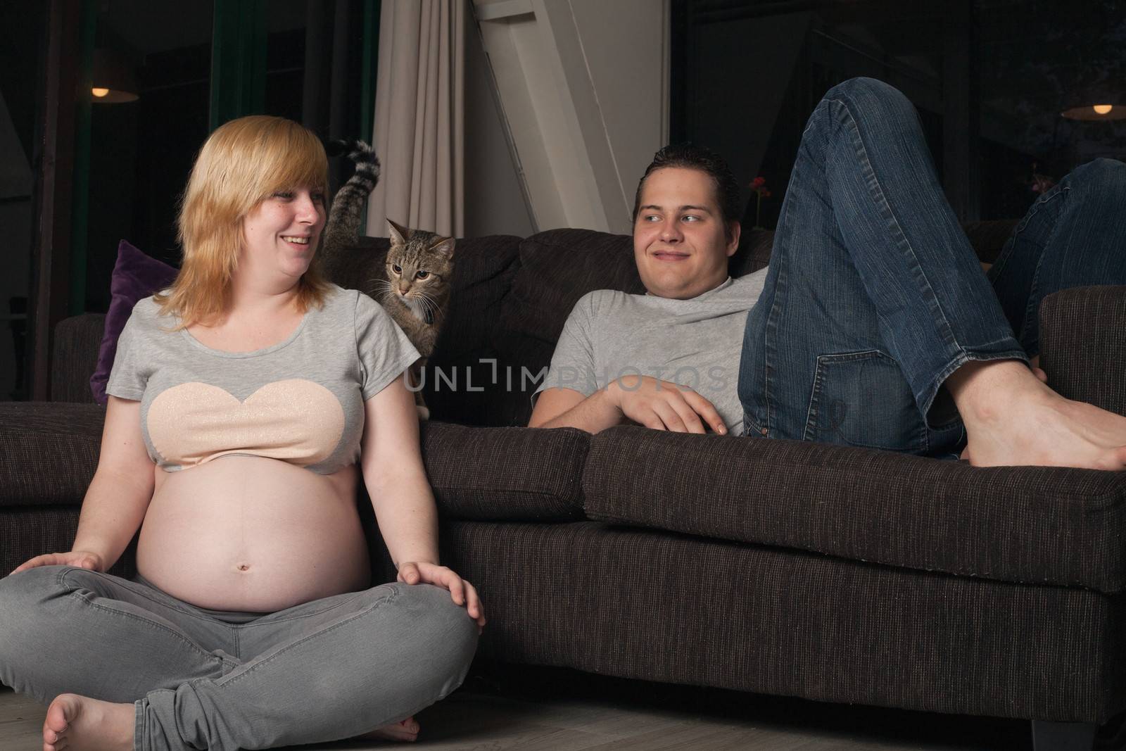 Young couple is waiting for their first child in the living room