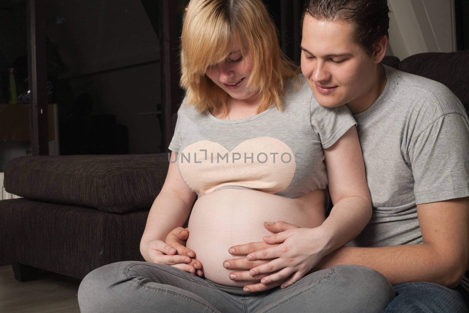 Young couple is waiting for their first child in the living room