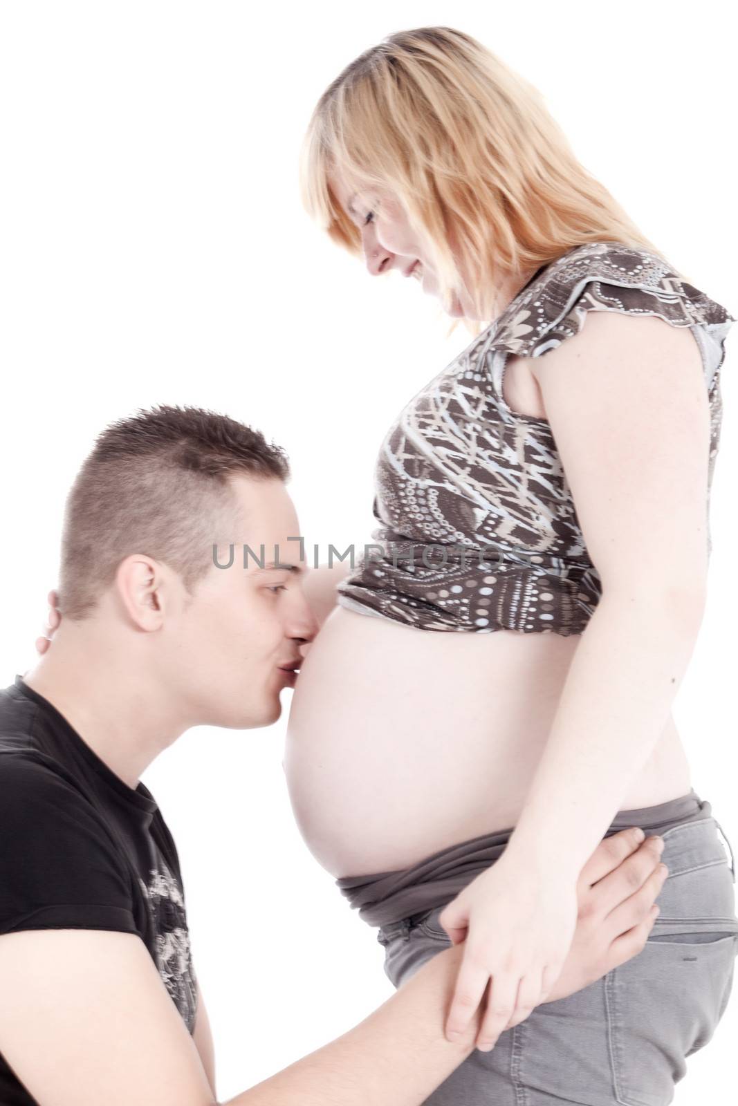 Happy young pregnant couple in the studio