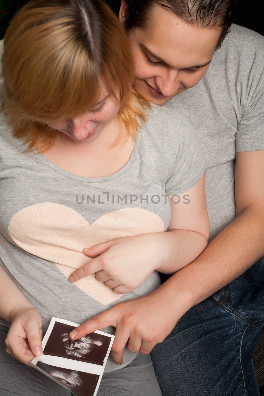 Young couple is waiting for their first child in the living room