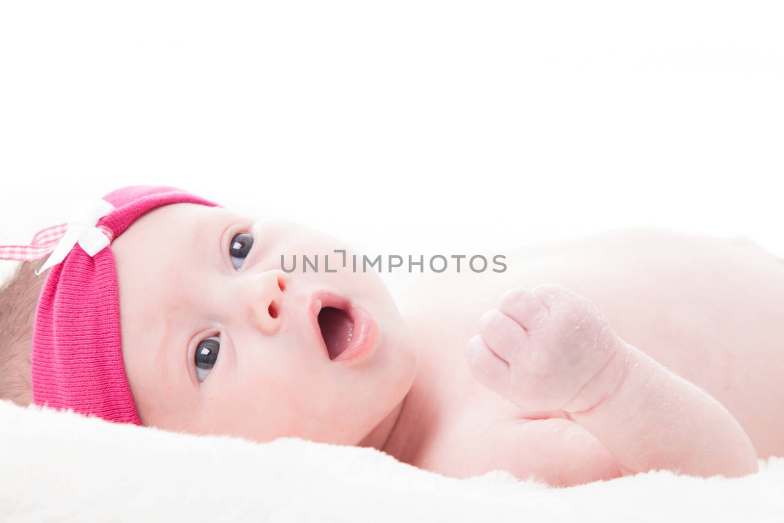 happy newborn baby girl just a week old photographed in the studio