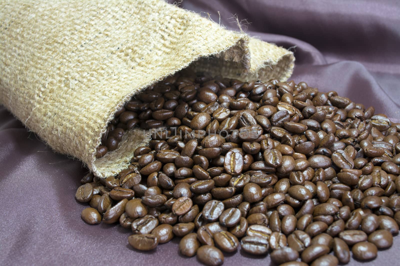 Detail of coffee beans and jute bag with background