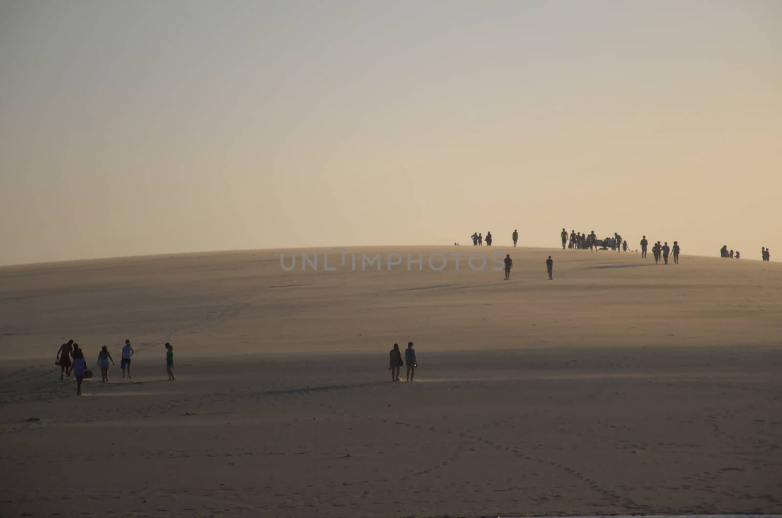 People on the dune top in Jericoacoara Beach by eldervs