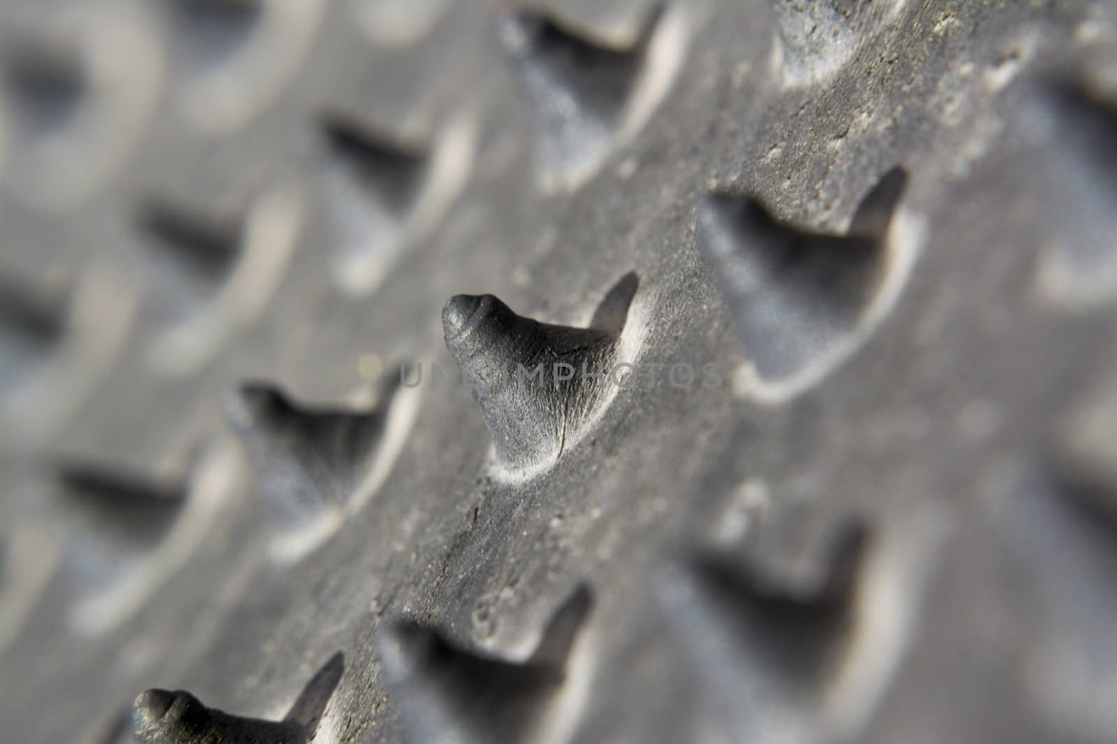 Pyramid-shaped protrusions, contrast and blur background of a piece of rubber