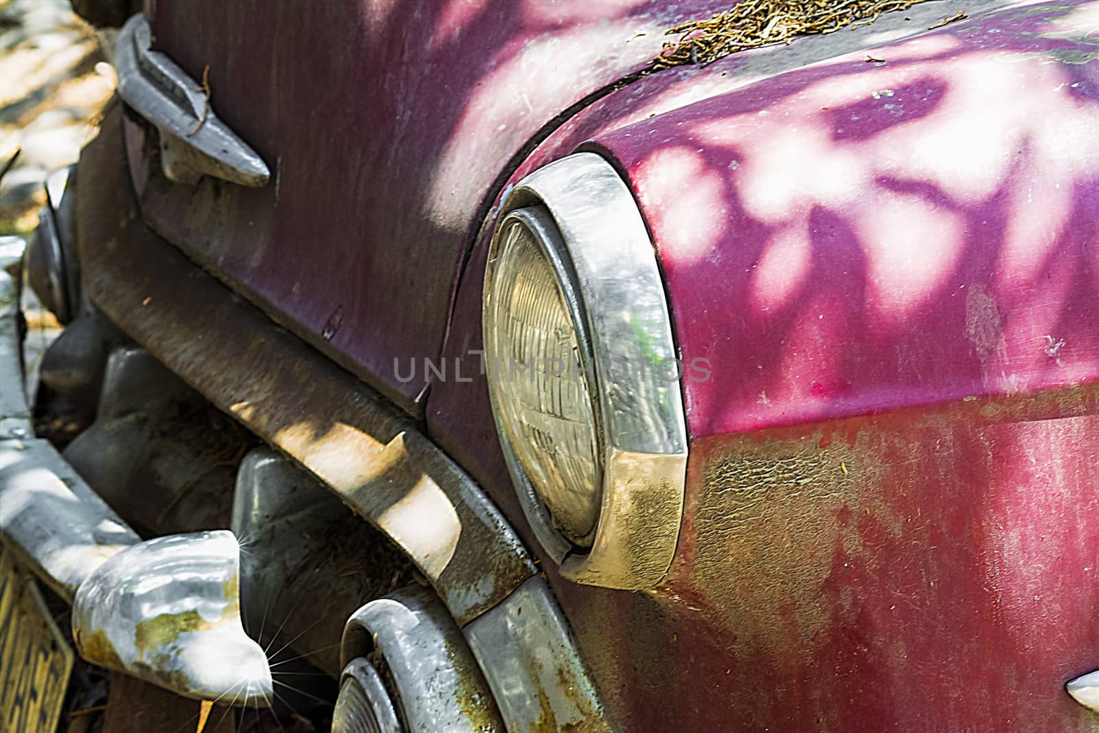 Front car abandoned and mistreated in red with chrome accents