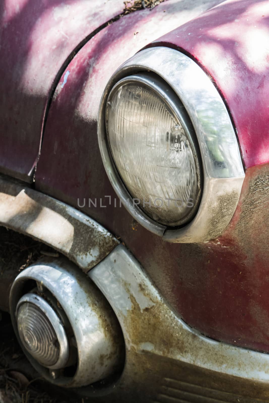 Front car abandoned and mistreated in red with chrome accents
