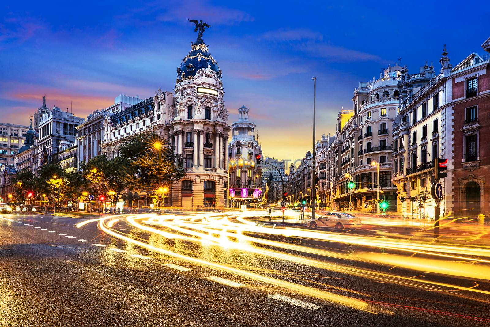 Rays of traffic lights on Gran via street, main shopping street in Madrid at night. Spain, Europe. 