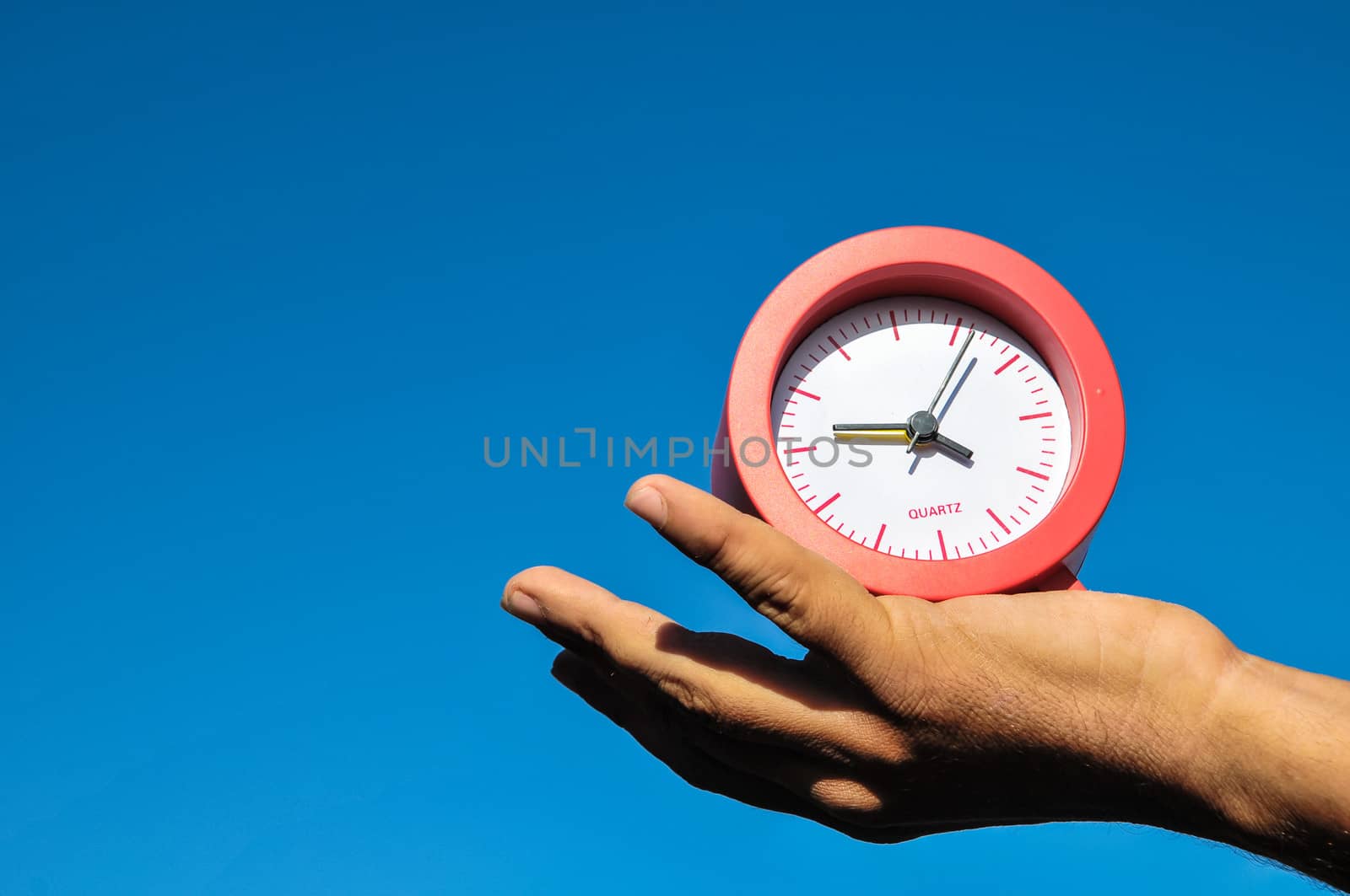 Time Concept White Sand Hourglass on the Volcanic Rocks