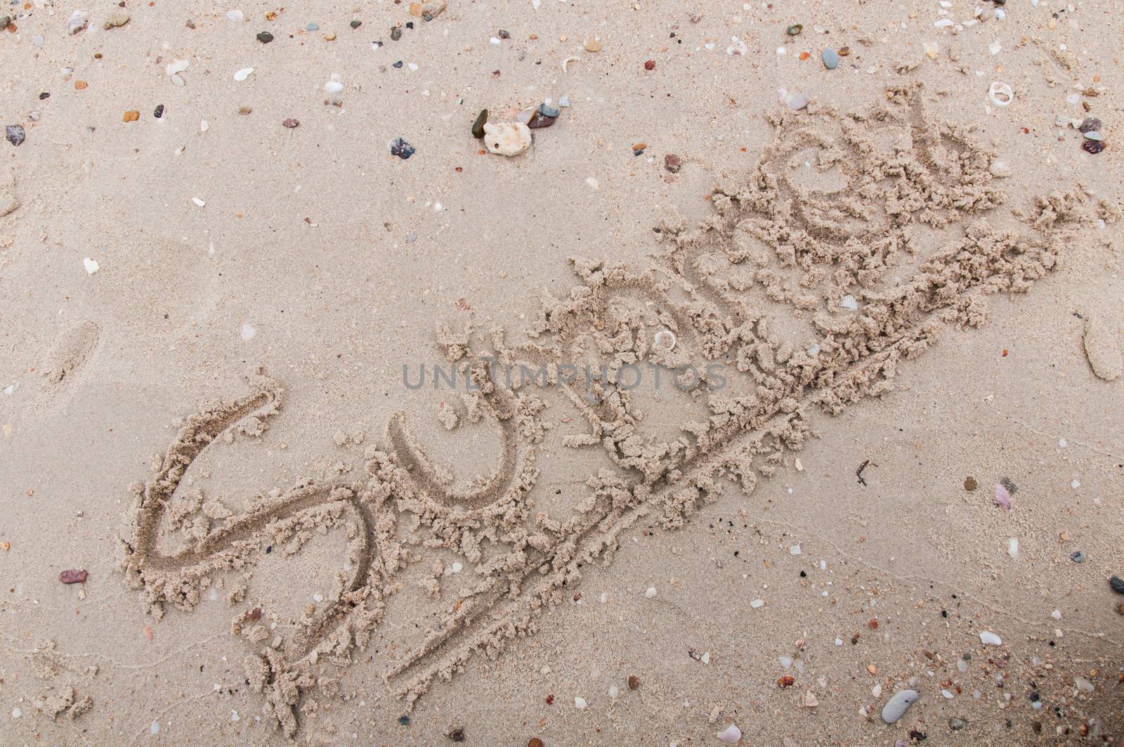 The word summer  handwritten in sand  by Sorapop
