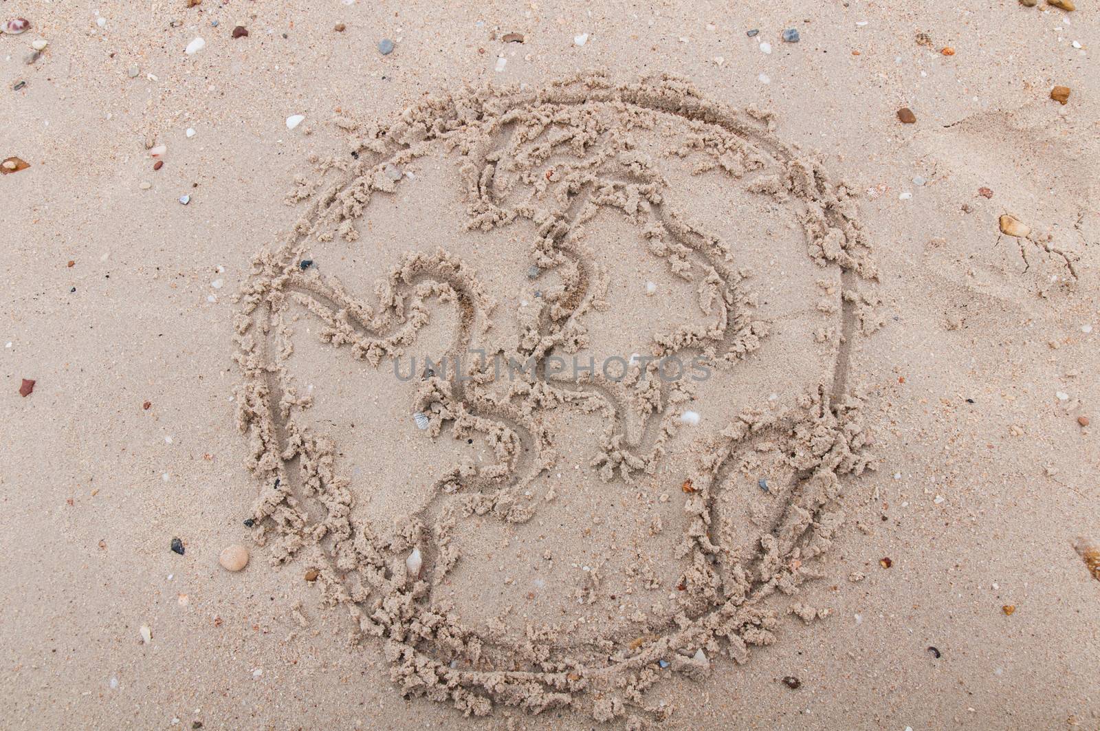 The word world handwritten in sand on a beach,