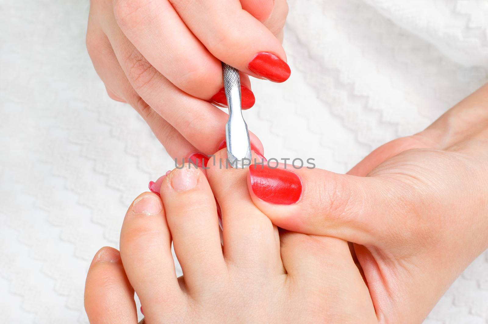 body care series. pedicure applying - toe nails cleaning and moisturizing with special solution.