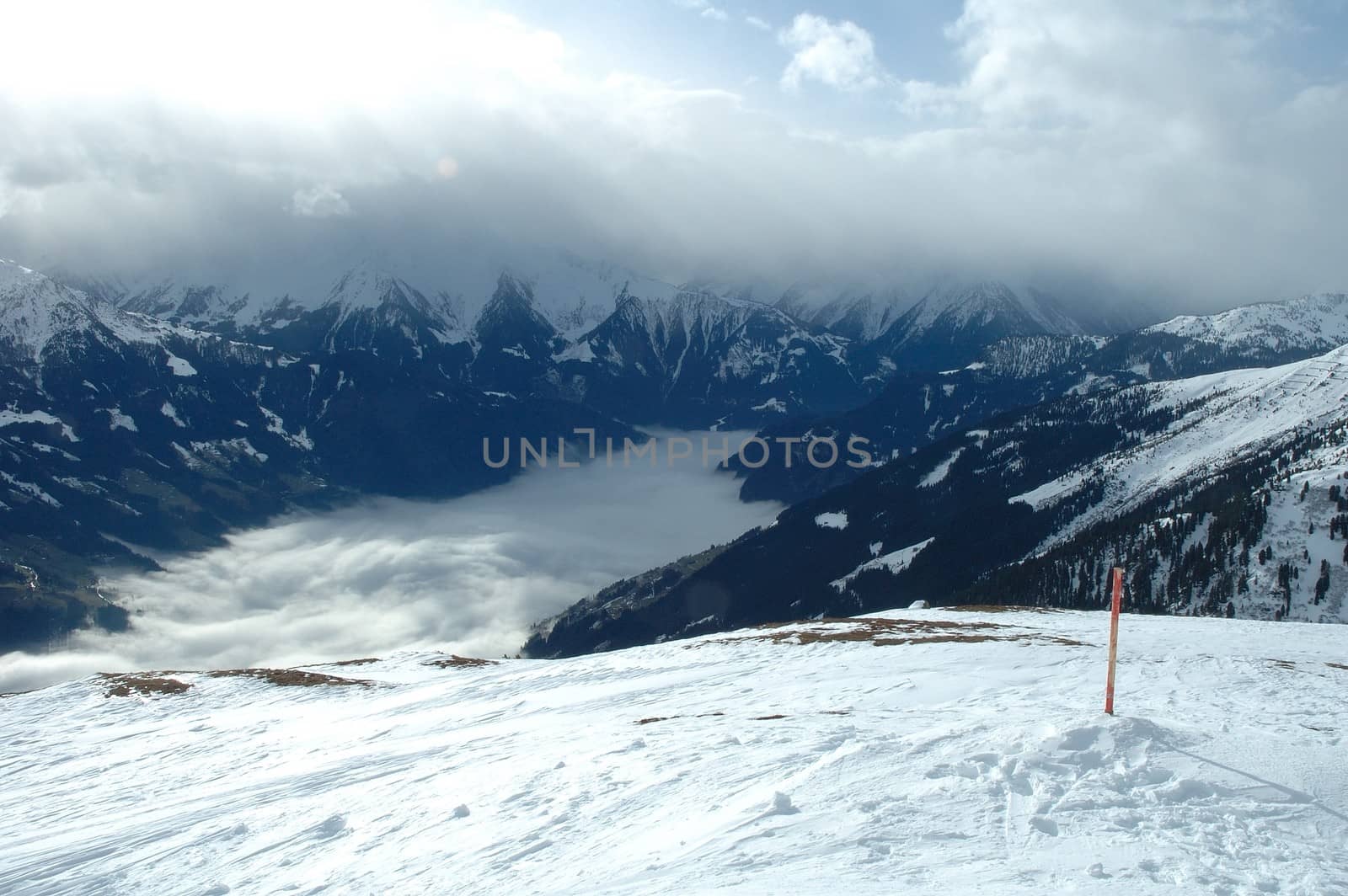Zillertal valley covered with clouds view from Ofelerjoch peak in Austria nearby Kaltenbach