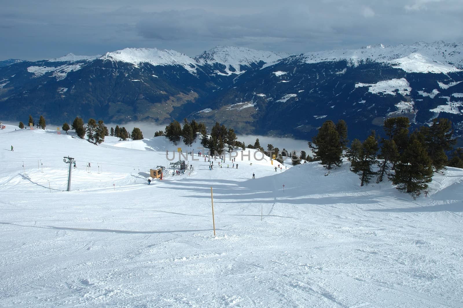 Ski slope, skiers and lift in Austria nearby Kaltenbach in Zillertal valley
