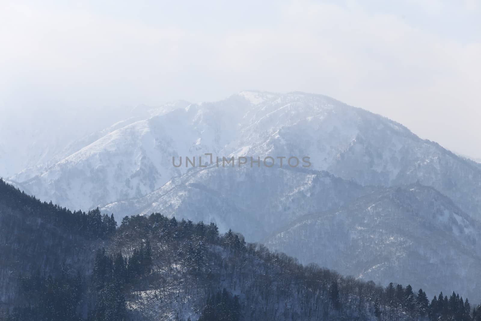 snow covered mountain in Takayama japan by rufous