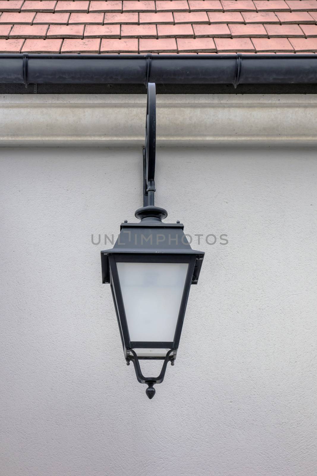 Old street lamp closeup on the wall