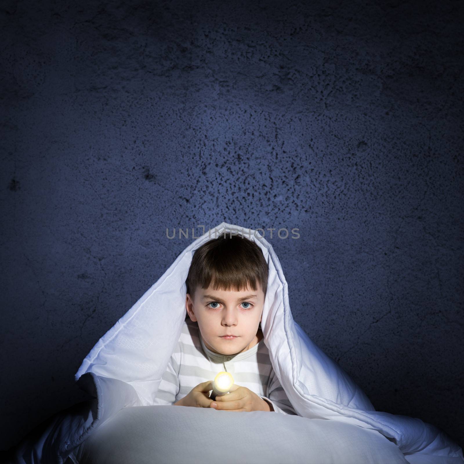 boy under the covers with a flashlight by adam121