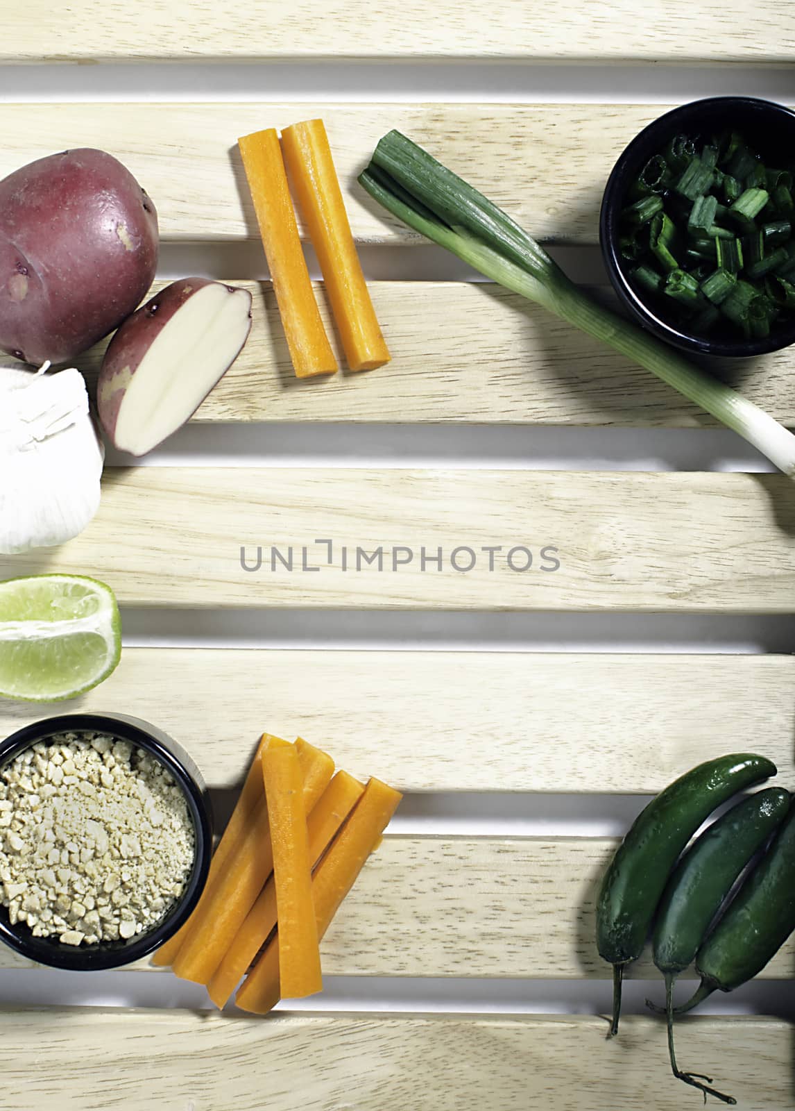 Arrangement of prepared vegetables on wood background