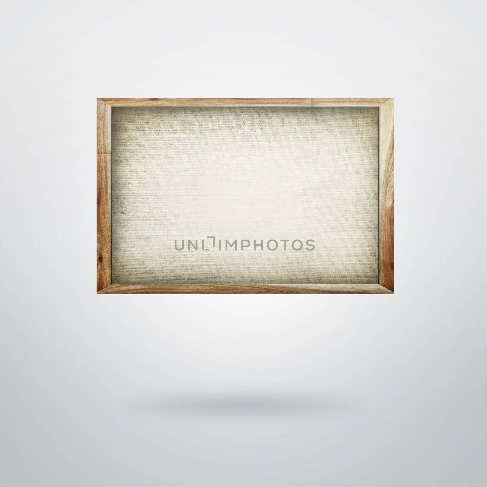 Blank canvas in frame on plain background