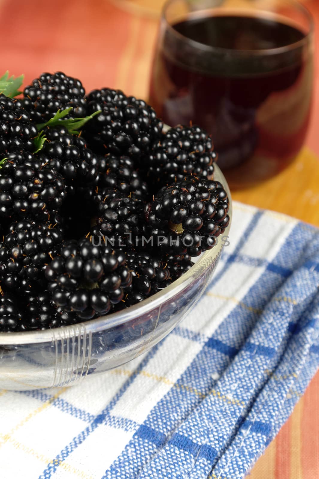 ripe mulberries on table with a juice