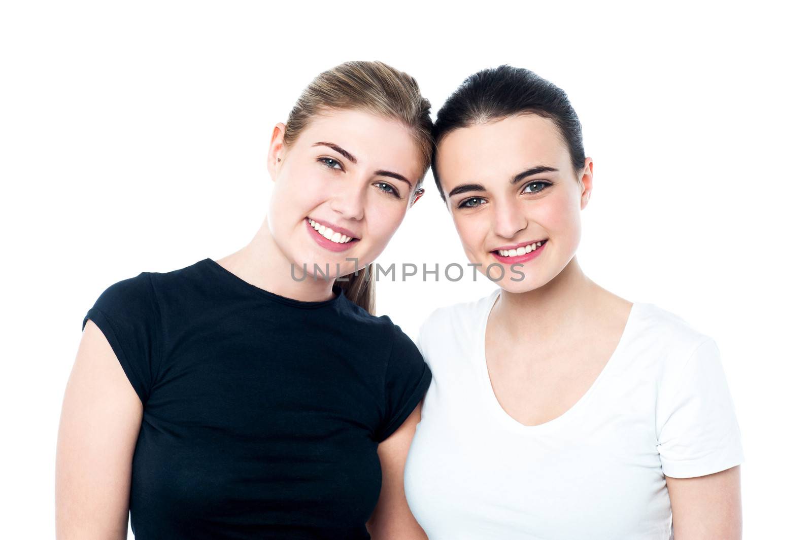 Young smiling girls looking at you by stockyimages