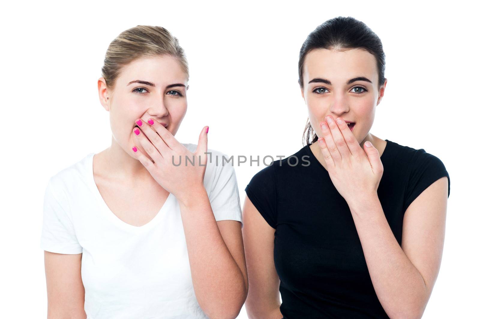 Surprised young girls laughing out loud by stockyimages