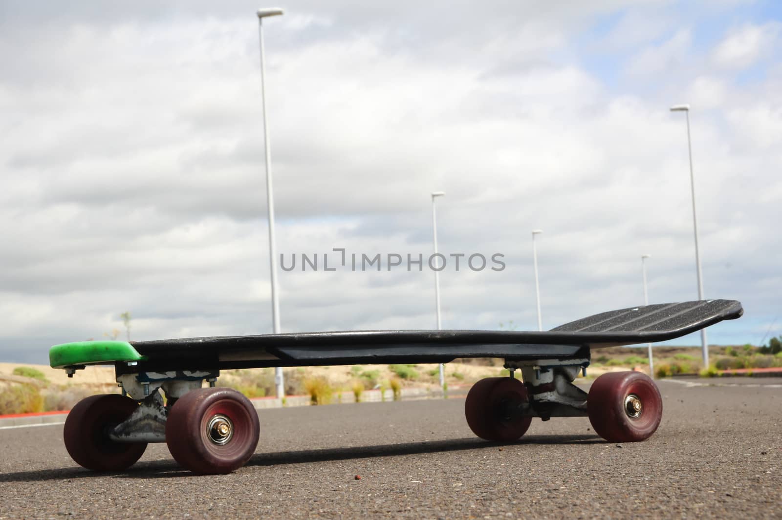 Vintage Style Longboard Black Skateboard on an Empty Asphalt Desert Road