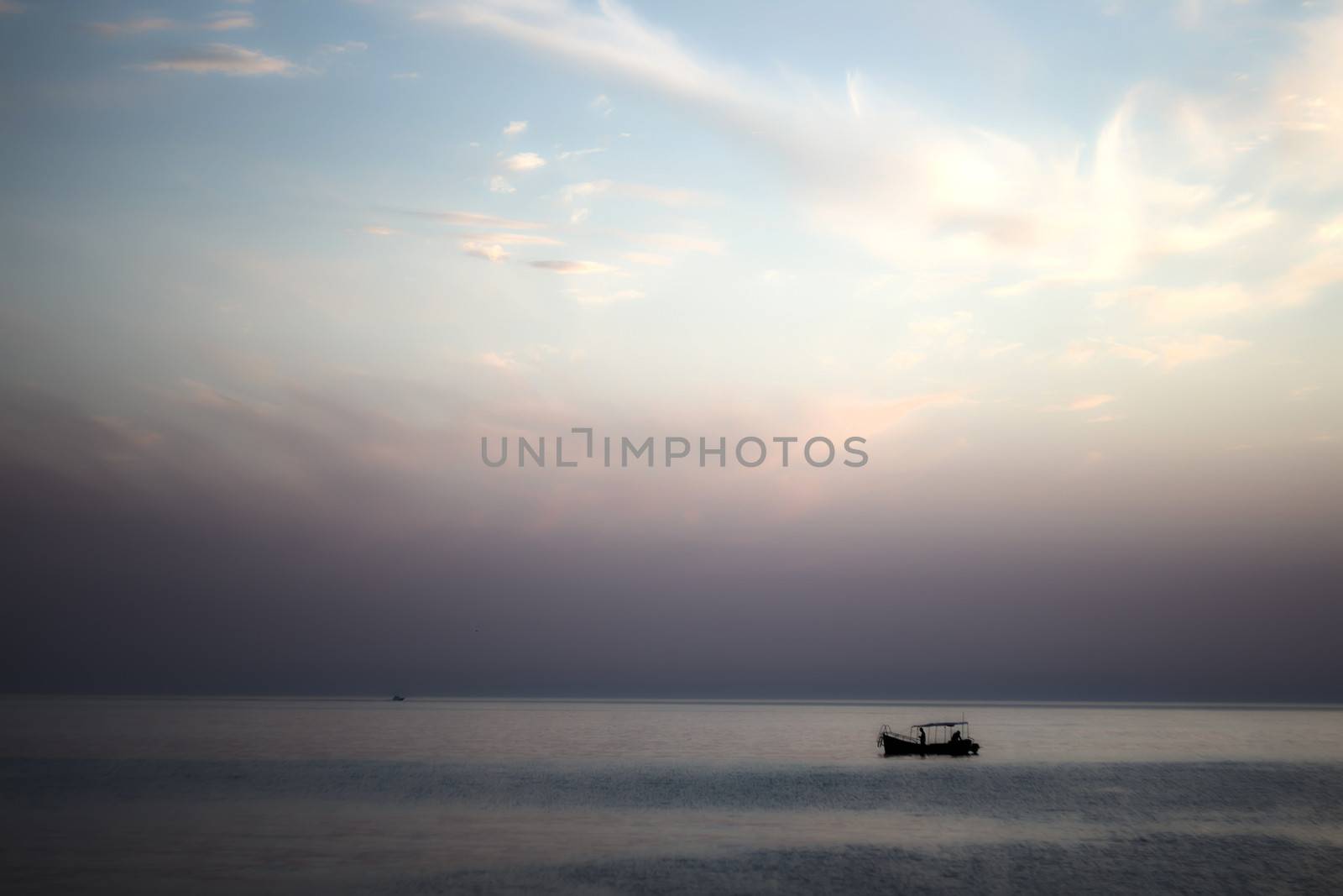 Fishing boat in the sea at sunset, southern coast of Crimea