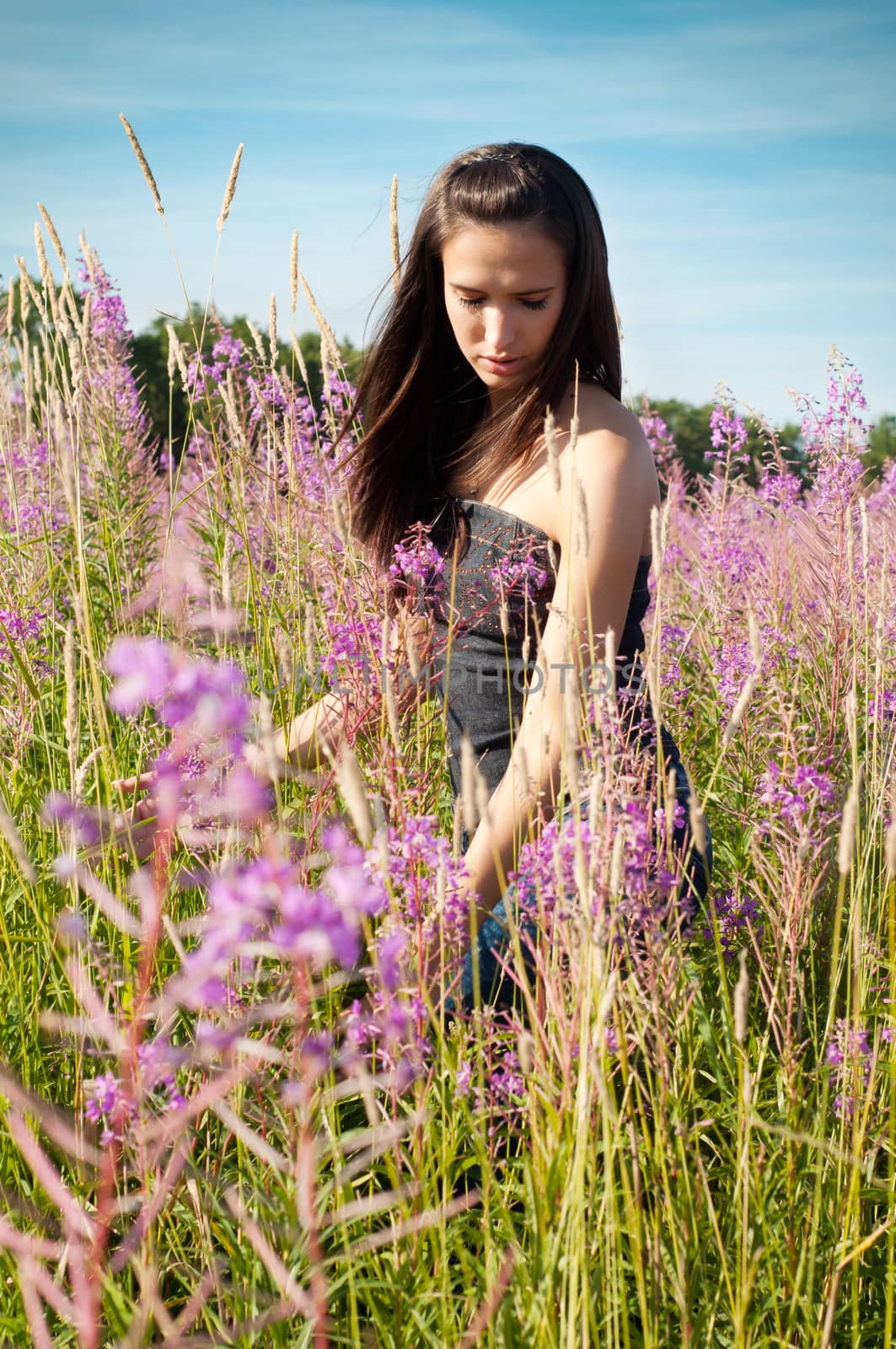 Outdoor shot of beautiful brunette woman with long hair