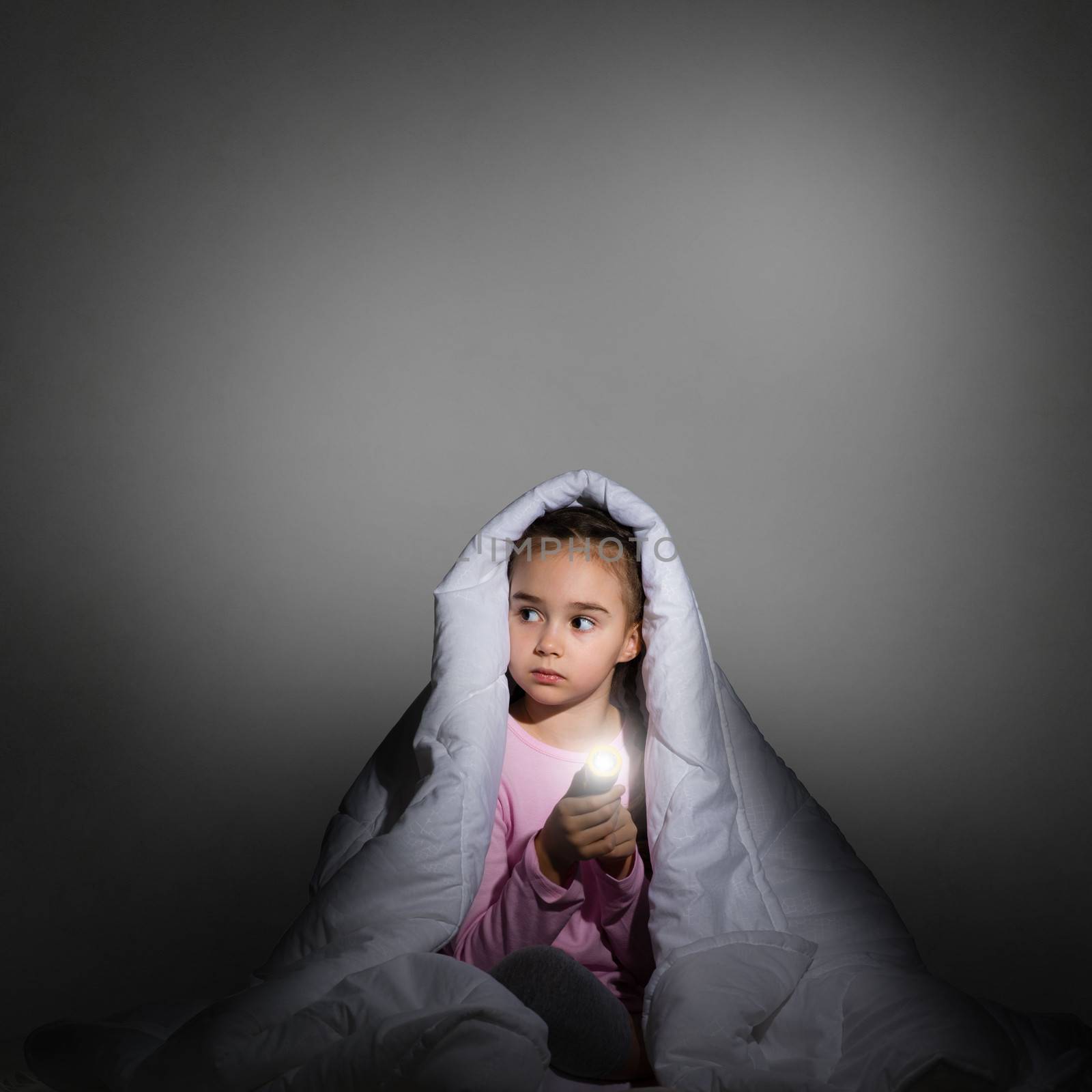 girl under the covers with a flashlight by adam121