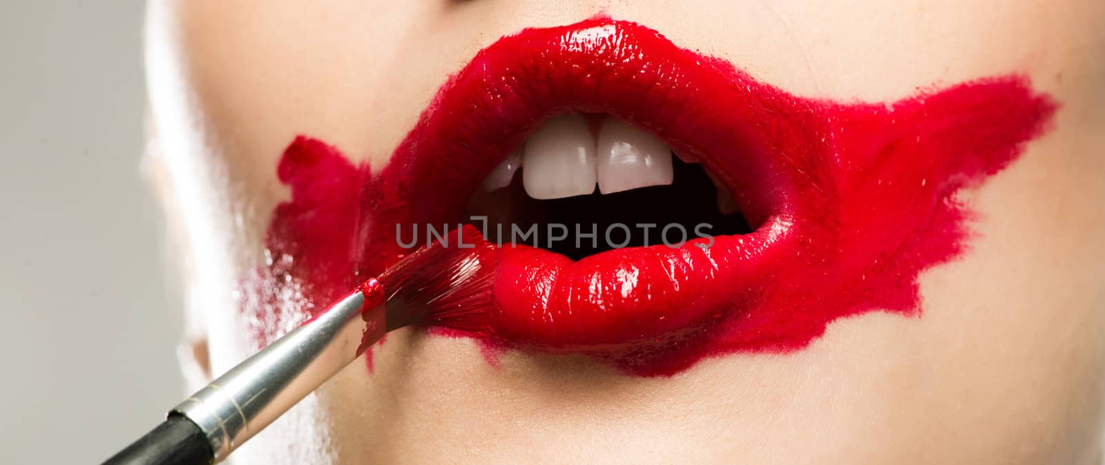 close-up of a female vivid red mouth, lipstick red paint