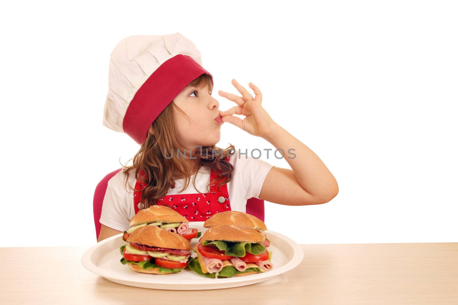 little girl cook with ok hand sign and sandwiches