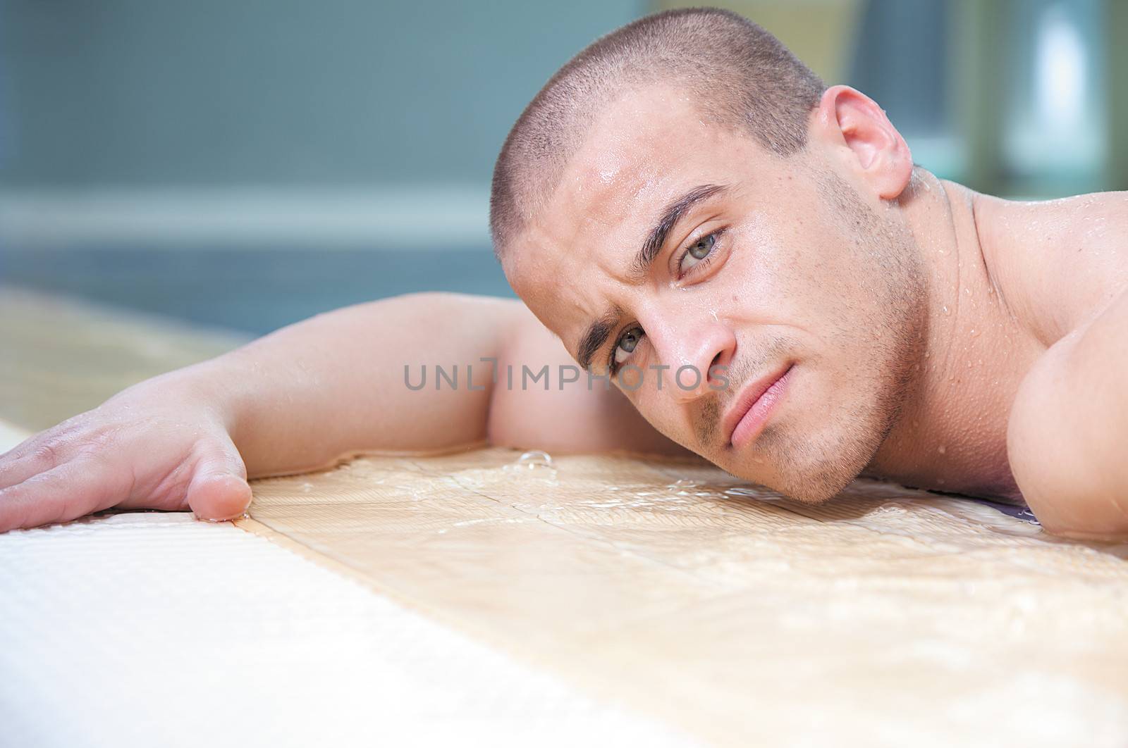 Young attractive male posing in a swimming pool