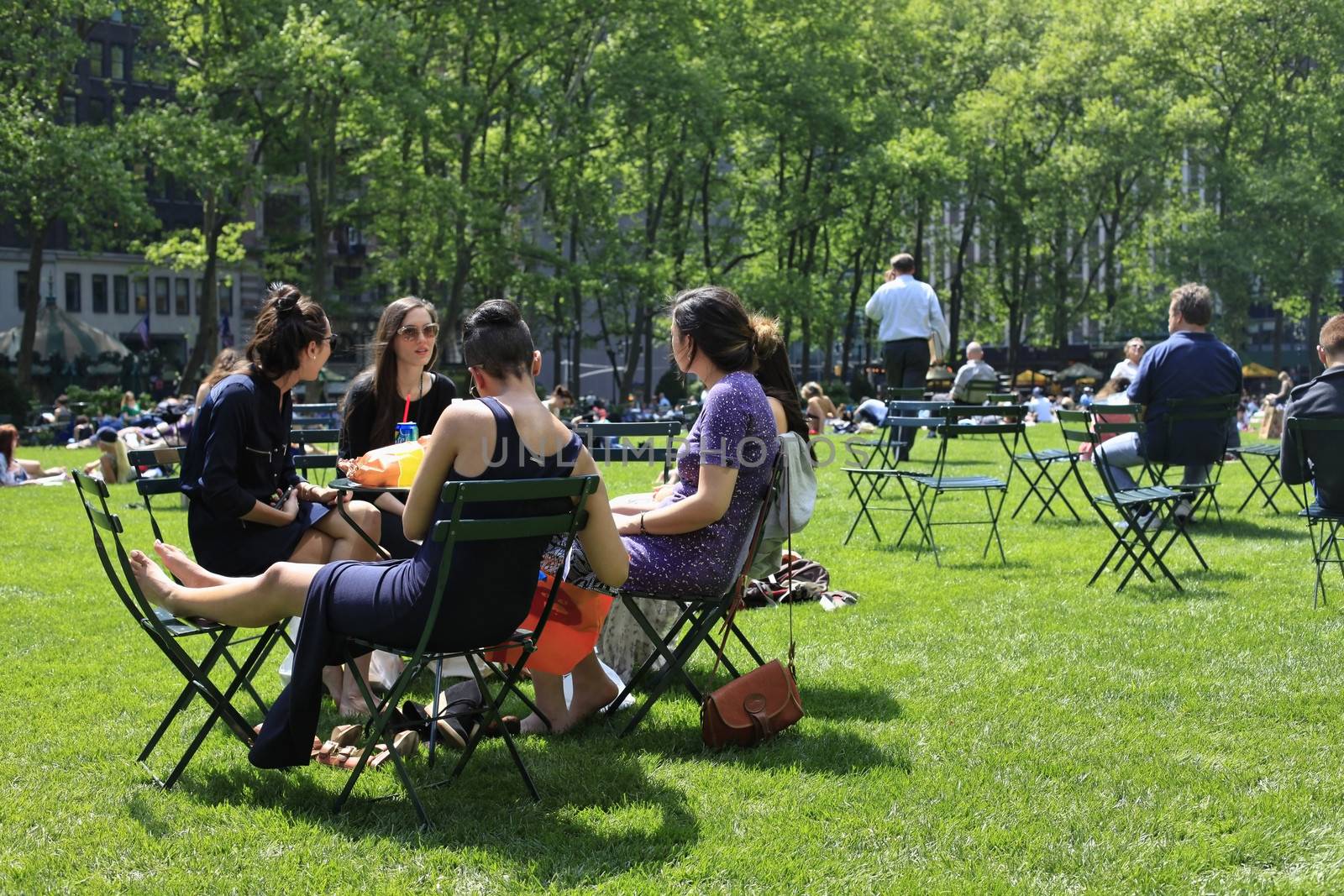 NEW YORK, USA - MAY 16: People enjoying a nice day in Bryant Park on May 16, 2013 in New York City, NY. Bryant Park is a 9,603 acre privately managed park in the center of Manhattan.