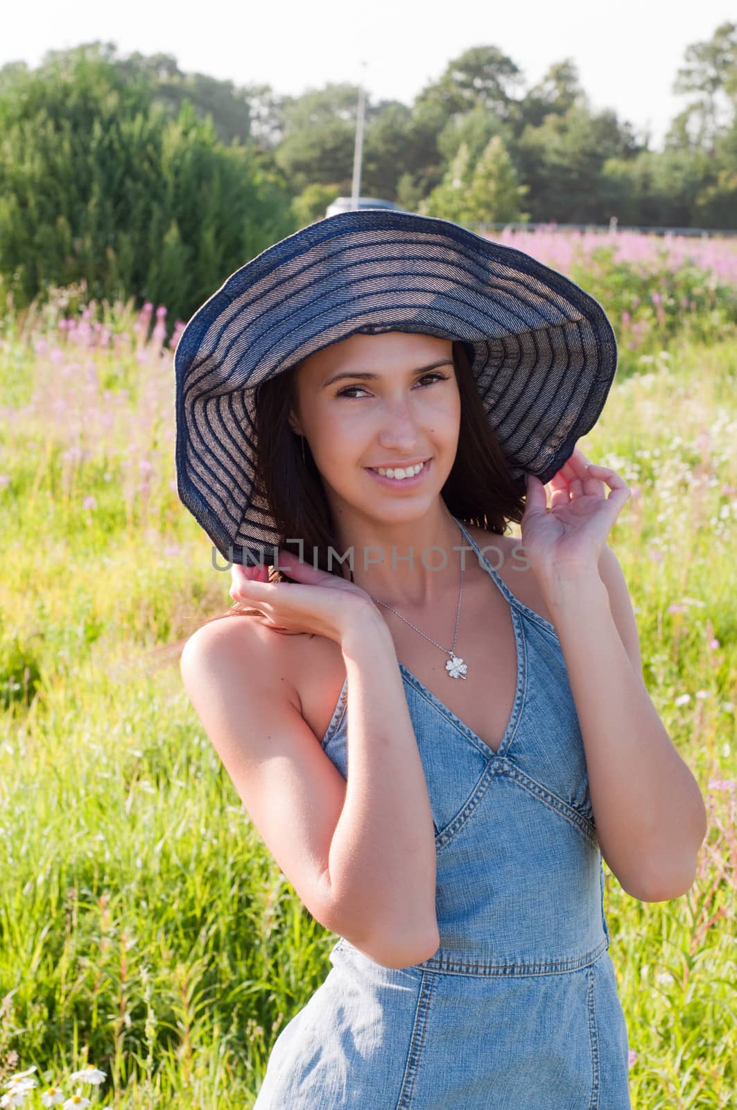 Outdoor shot of beautiful brunette woman with long hair